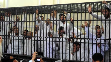 Supporters of former Egyptian president Mohammad Mursi, standing trial on charges of violence that broke out in Alexandria last year, react after two fellow supporters were sentenced to death, March 29, 2014. (Reuters)