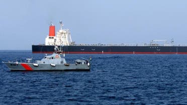 A UAE police boat sails past the M Star oil tanker at sea near Fujairah port in the United Arab Emirates July 29, 2010
