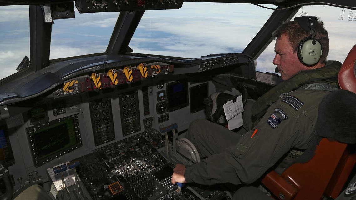 Royal New Zealand Air Force P3 Orion co-pilot Squadron Leader Brett McKenzie flies the plane while searching for missing Malaysia Airlines flight MH370, over the Indian Ocean on March 31, 2014. (AFP)