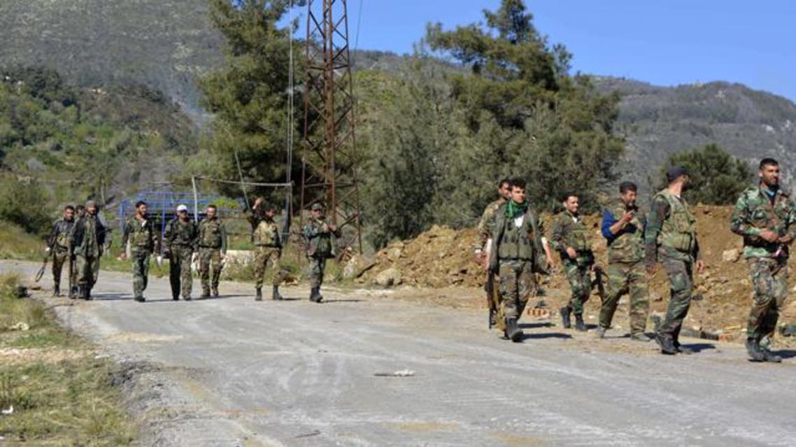 Pro-regime soldiers are seen marching on a road in the village of Kasab, in the northwestern province of Latakia, on March 27, 2014. (AFP)