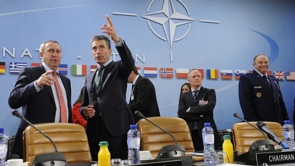 Ukraine Foreign Affairs minister Andrii Deshchytsia (L) speaks with NATO Secretary General Anders Fogh Rasmussen (2ndL) during the Nato-Ukraine Foreign Affairs meeting at the NATO headquarters in Brussels on April, 01 2014. (AFP)