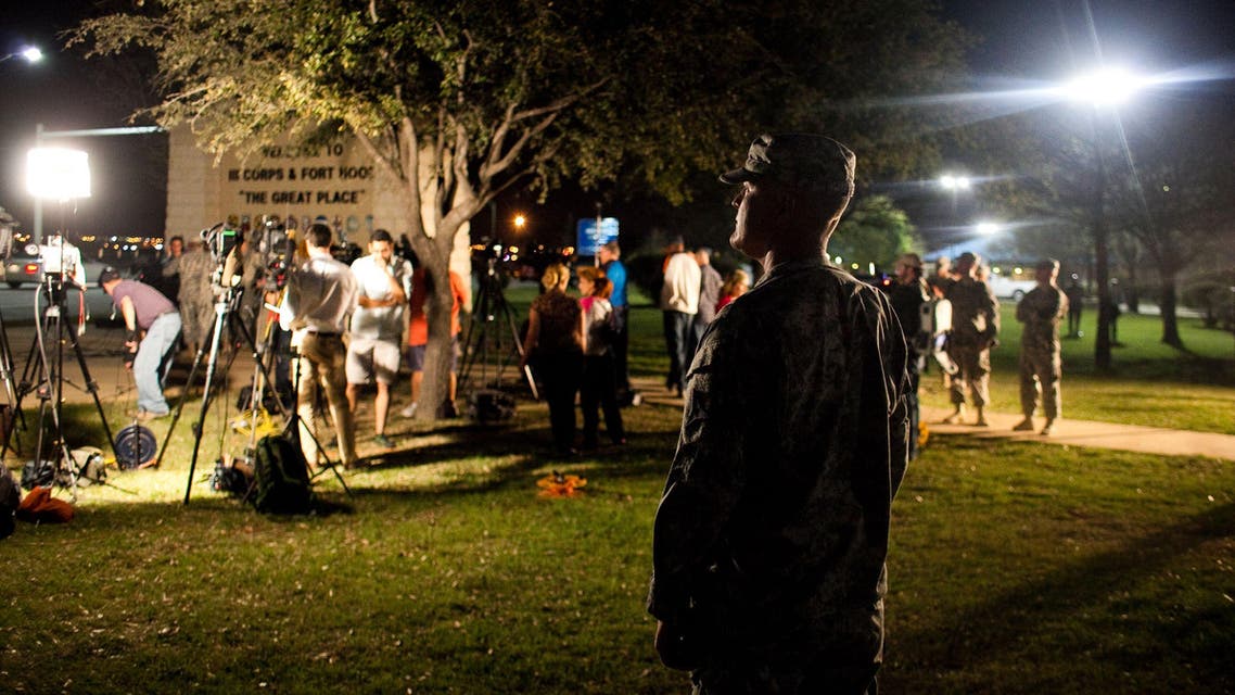 A soldier watches over media as they prepare to hear General Mark Milley, III Corps and Fort Hood Commanding General, speak during a press conference at Fort Hood Military Base on April 2, 2014 in Fort Hood, Texas. (AFP)