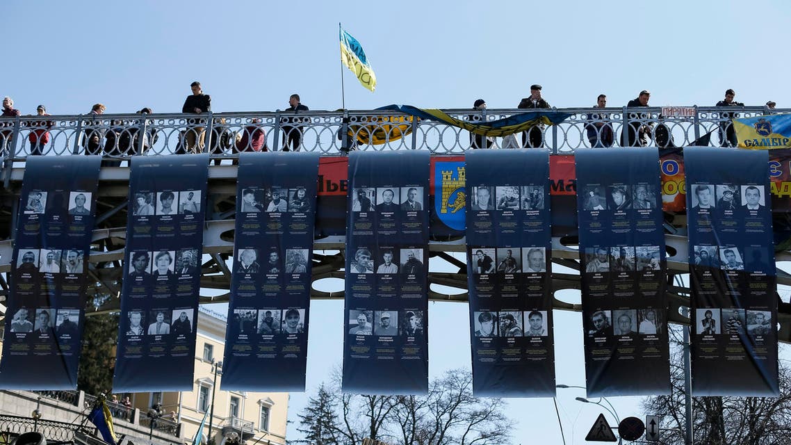 Posters with images of people killed in recent clashes are seen at the site of the clashes in Kiev March 30, 2014. (Reuters)