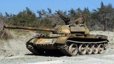 a pro-government fighter standing on a tank at an undisclosed location in the north of Syria's Latakia province. (AFP)