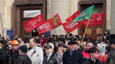 Pro-Russian activists hold red flags with the communist hammer and sickle and the soviet "USSR" initals during a rally at the regional administration building in the eastern Ukrainian city of Kharkiv on April 7, 2014. (AFP)