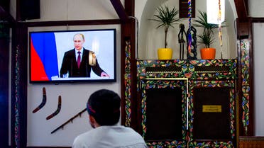 A man watches a speech by Russian President Vladimir Putin in a restaurant in Simferopol, Crimea on March 18, 2014. (File photo: Reuters)