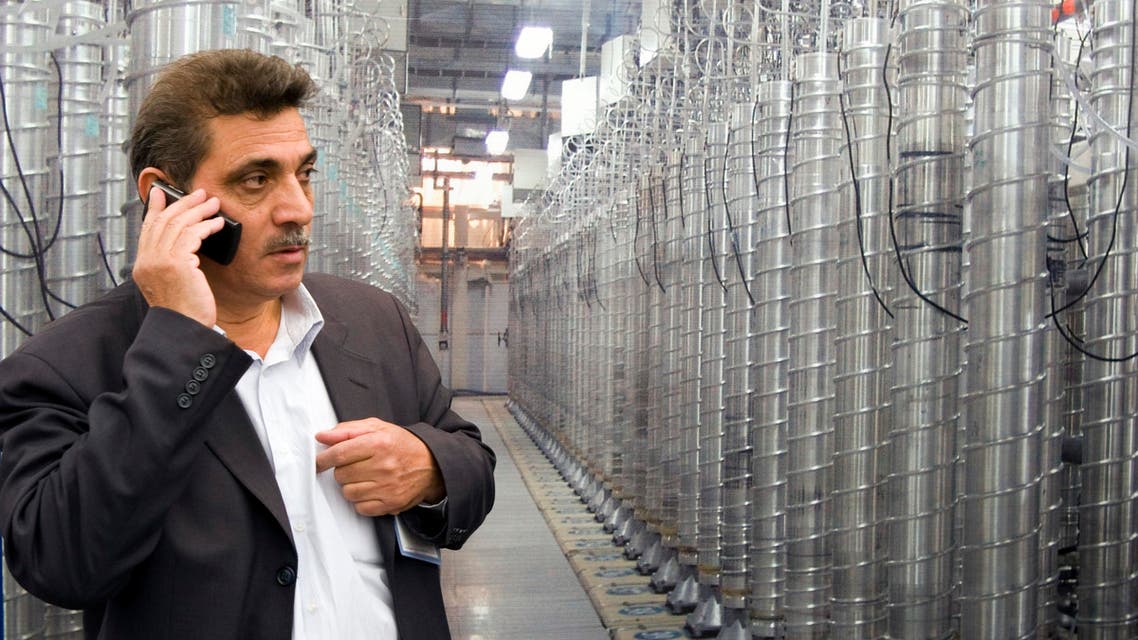 An official from Iran's Atomic Energy Organization speaks on his mobile phone in front of uranium enriching centrifuges at an exhibition of Iran's nuclear achievements at Shahid Beheshti University in Tehran April 20, 2009. (File: Reuters)