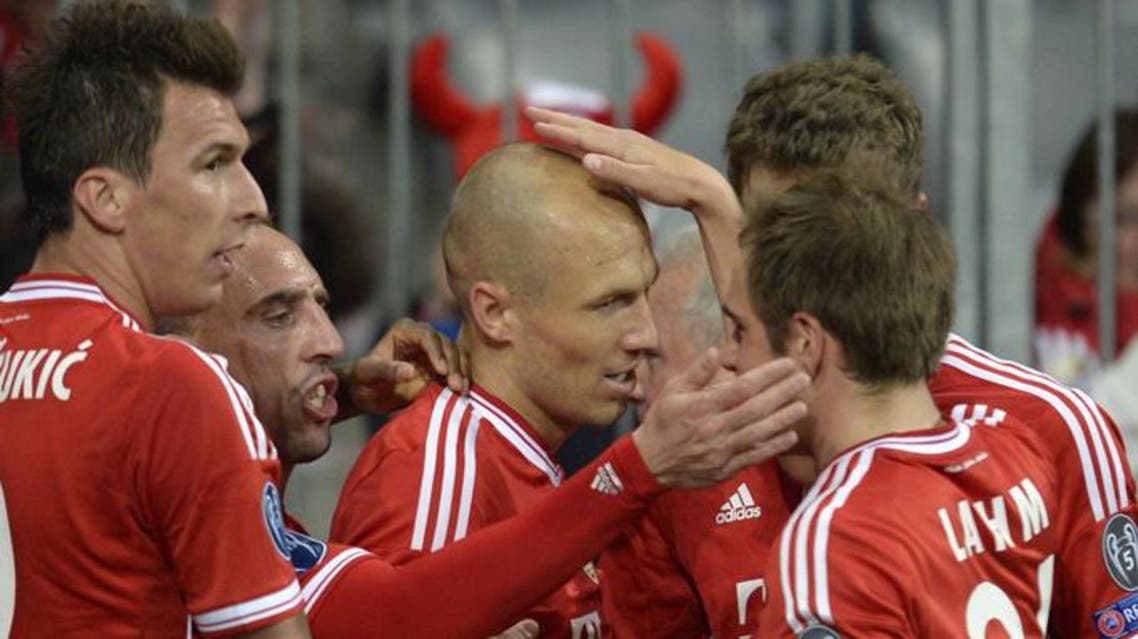 Bayern Munich's Dutch midfielder Arjen Robben (C) celebrates with teammates after scoring during the UEFA Champions League quarter-final second leg football match Bayern Munich vs Manchester United in Munich, southern Germany, on April 9, 2014.