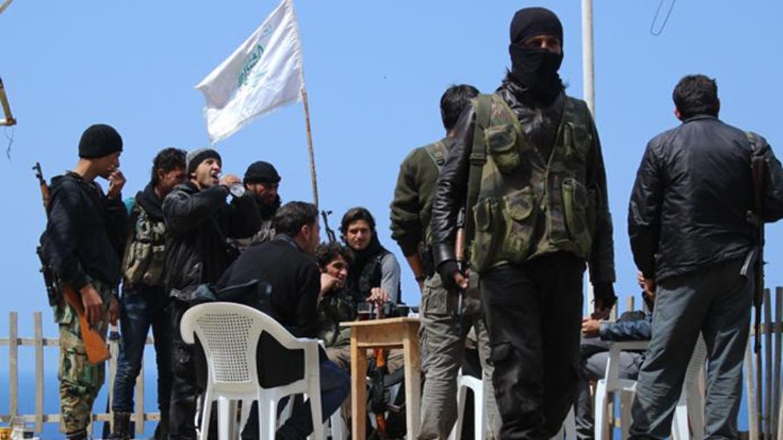Rebel fighters from the Ansar al-Sham brigade hold a position on a ridge overlooking the Mediterranean sea reportedly in the village of Kasab, in the northwestern Syrian province of Latakia. (Reuters)