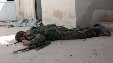 A badly wounded opposition fighter lies on the ground during reported clashes between rebels and Syrian government forces in the northern city of Aleppo on April 9, 2014. (AFP)