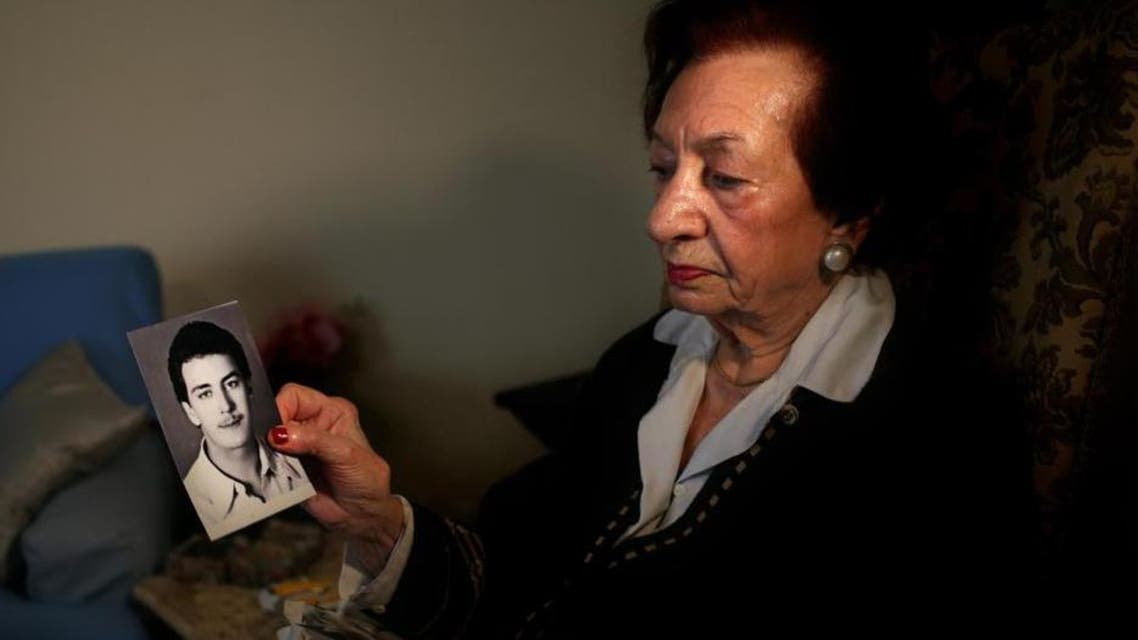 Lebanese Mary Mansourati, 82, whose son Dani went missing in Syria in 1992 at the age of 30, show his portrait during an interview with the Associated Press at her house, in Beirut, Lebanon. (AP)