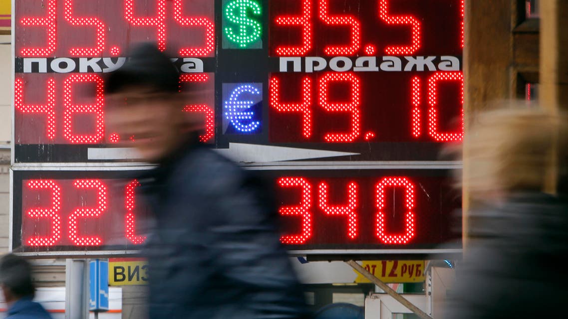 People pass by a board displaying exchange currency rates in Moscow, April 3, 2014. (Reuters)