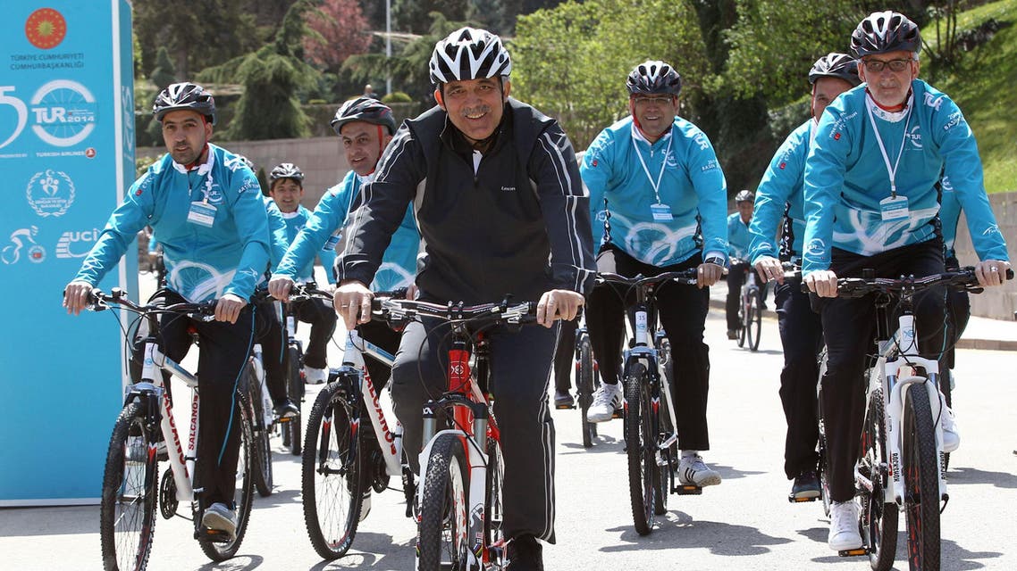 Turkish President Abdullah Gul (C) rides a bicycle before the start of the Presidential Bicycle Tour, cycling tour of Turkey, in Ankara on April 11, 2014. (Reuters)