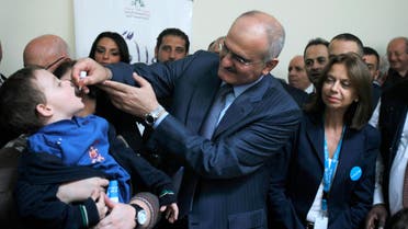 Lebanon's Caretaker Health Minister Ali Hassan Khalil administers a polio vaccination to a boy at a hospital near Zahle town in the Bekaa Valley November 8, 2013. (File photo Reuters)