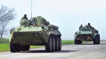 Ukrainian armoured personnel carriers (APC) drive in the Donetsk region on the road from Donetsk to Odessa on April 15, 2014. (AFP)