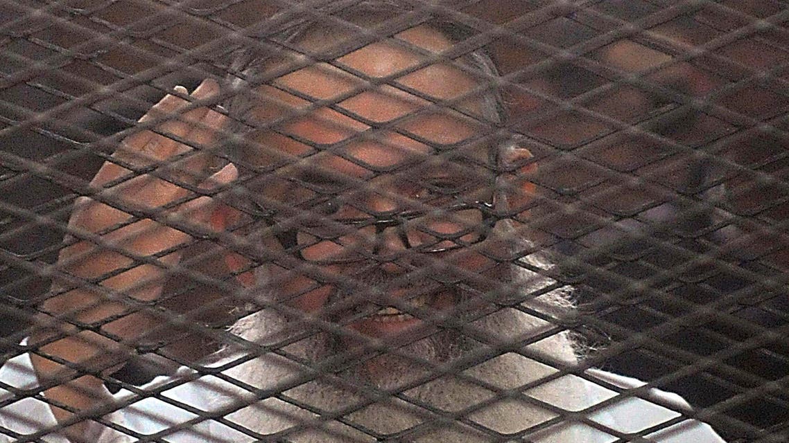 Egypt's Salafi leader and former presidential candidate Hazem Salah Abu Ismail looks on from the defendant cage during his trial in Cairo Dec. 19, 2013.  (R