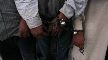 Handcuffed men stand in line at the Crime Investigation Department (CID) after their arrest in Karachi, Jan. 2, 2013. (File photo Reuters)
