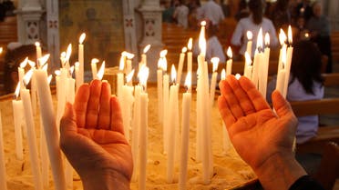A Syrian woman prays as she attends a mass of an Orthodox Easter at the Roman Orthodox patriarchate in Damascus  reuters