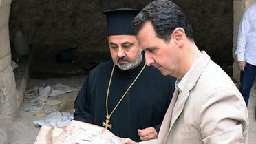 A picture uploaded on the official Facebook page of the Syrian Presidency on April 20, 2014, shows Syria's President Bashar al-Assad looking at icons as he visits a monastery in the ancient Christian town of Maalula which his troops recently recaptured from rebels.