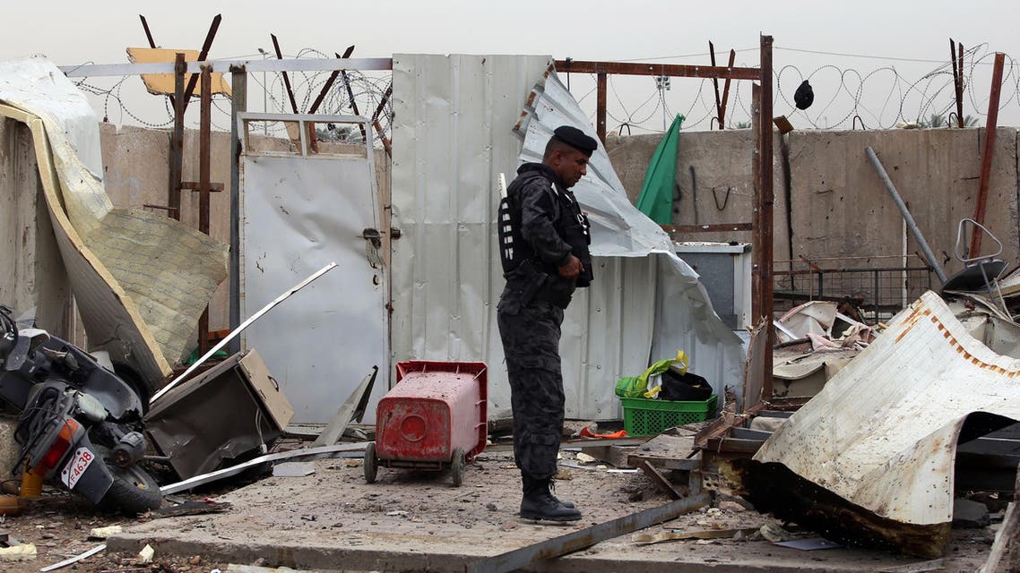 An Iraqi policeman inspects the site of a suicide bombing at the university of Imam Kadhim University in the capital Baghdad on April 20, 2014. (AFP)