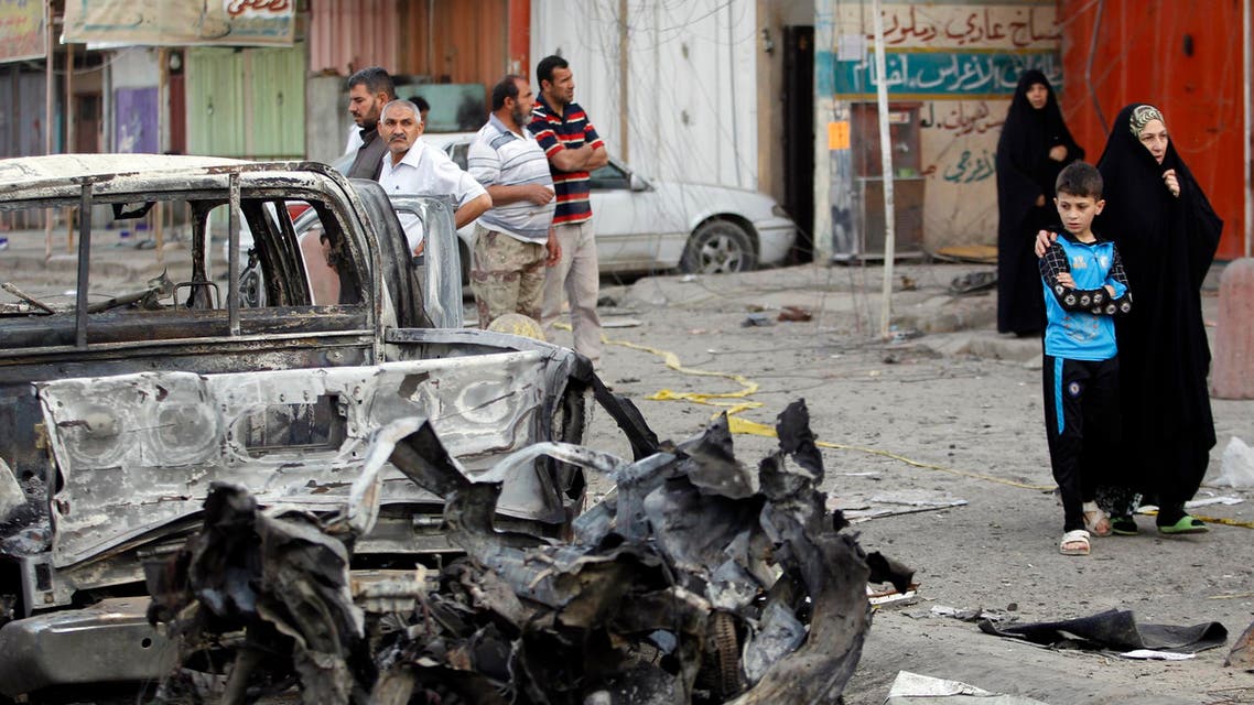 People gather at the site of a bomb attack in Baghdad's Habibiya district, April 17 2014. At least eight people were killed in the car bomb attack in a predominantly Shi'ite neighbourhood on the eastern edge of the capital Baghdad on Wednesday, hospital and police officials said. More than 26 others were wounded in the attack that took place in a busy commercial area in Habibiya district of the Shi'ite working-class district of Sadr City, just few metres away from the district's police centre.