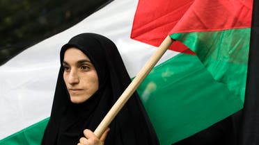 A woman holds a Palestinian flag outside the United Nations headquarters building in Tehran REUTERS