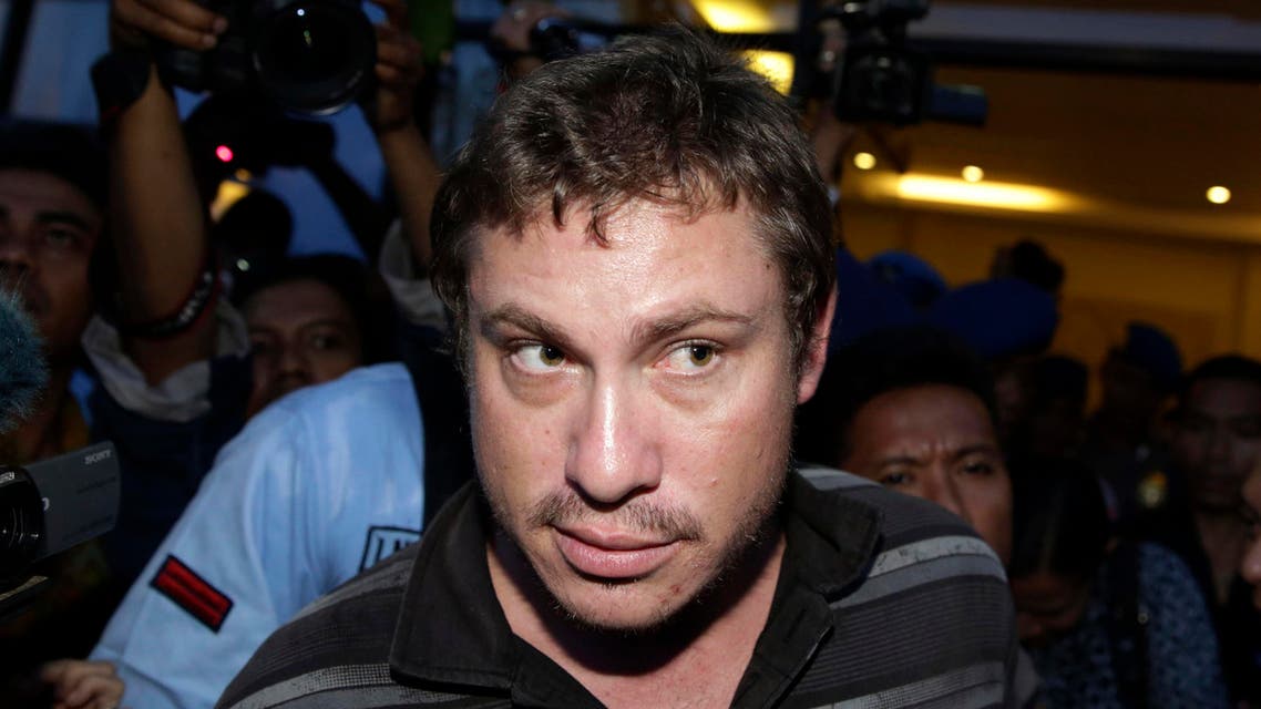 Matt Christopher, a passenger of Virgin Australia, walks following his arrest at Denpasar airport in the resort island of Bali April 25, 2014. reuters