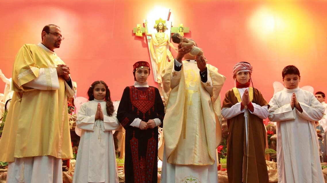 Christian children from Jordan, Syria, Iraq and Egypt, participate during a Christmas Mass in Amman reut