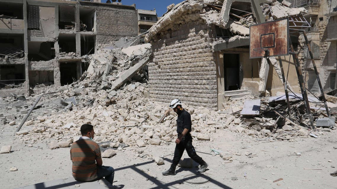 A rusty basketball hoop stands amid destruction in the courtyard of the Ain Jalout school that was heavily damaged by reported air strikes by government forces in the Ansari district of the northern Syrian city of Aleppo on April 30, 2014. (AFP)