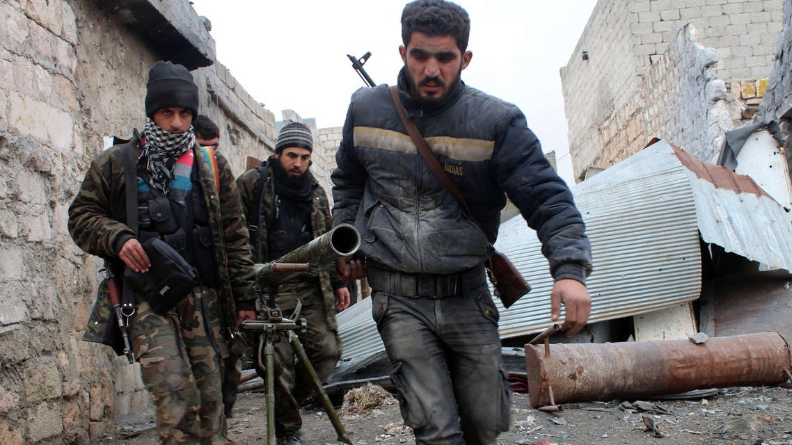 A file picture shows opposition fighters carrying a rocket launcher during clashes against Syrian government forces. (AFP)