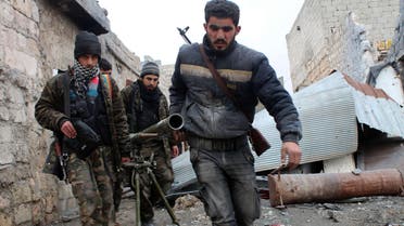A file picture shows opposition fighters carrying a rocket launcher during clashes against Syrian government forces. (AFP) 