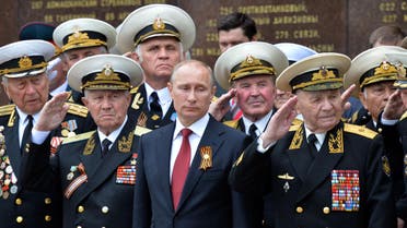 Russia's President Vladimir Putin (C) and World War II veterans watch a parade of honor guard during his visit to the Crimean port of Sevastopol on May 9, 2014. (AFP)