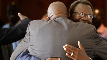 South Sudan's rebel leader Riek Machar (R) greets his friend at Sheraton Hotel in Addis Ababa May 9, 2014. South Sudan's President Salva Kiir arrived on Friday in Ethiopia's capital for the first face-to-face talks with Machar to try to end four months of conflict and avert a possible genocide. 