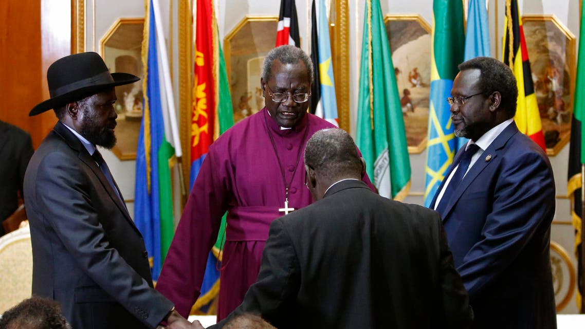 South Sudan's rebel leader Riek Machar (R) and South Sudan's President Salva Kiir (L) hold a priest's hands as they pray before signing a peace agreement in Addis Ababa May 9, 2014. reuters