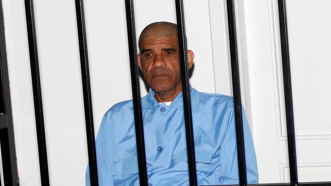 Abdullah al-Senussi, former spy chief under the government of late Libyan leader Muammar Gaddafi, sit behind bars during a hearing at a courtroom in Tripoli May 11, 2014. (Reuters)