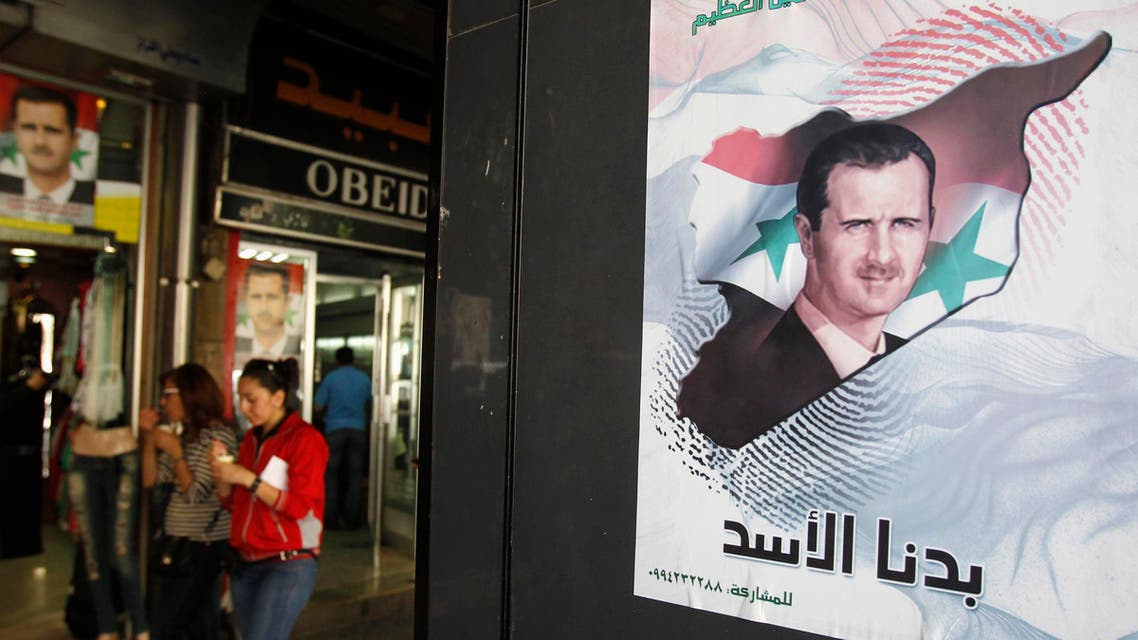A poster of Syrian President Bashar al-Assad is seen at a street in Damascus April 28, 2014. Reuters