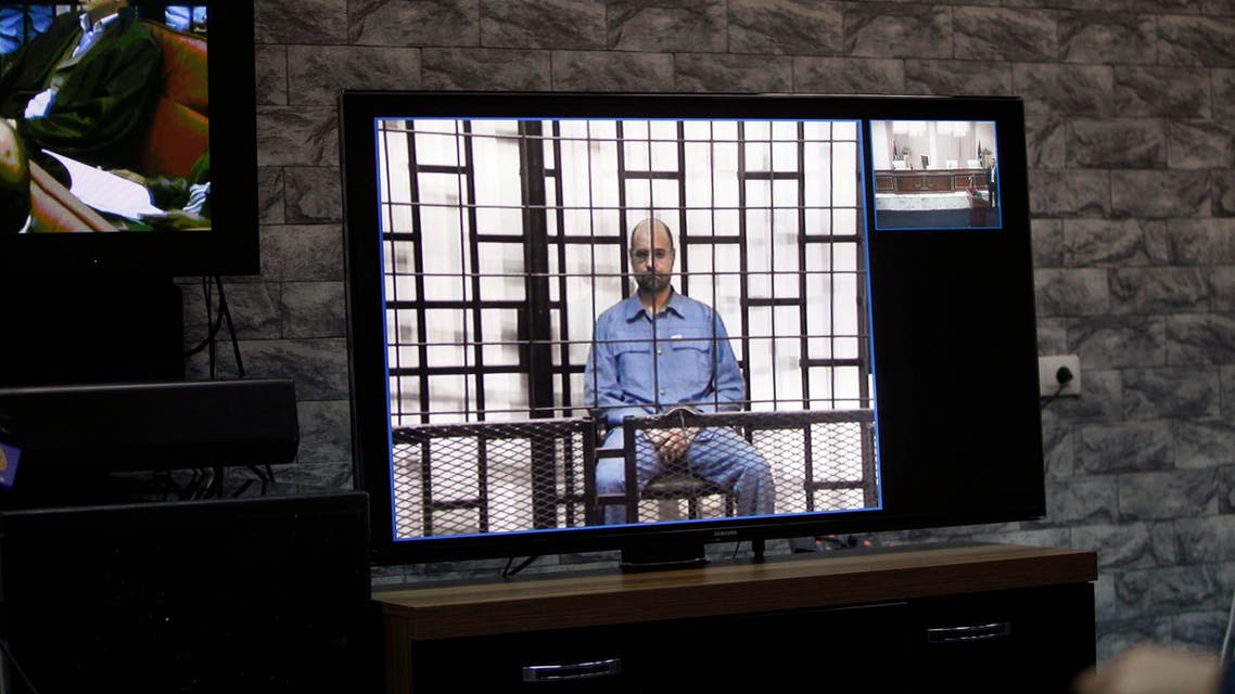 Saif al-Islam Gaddafi, son of late Libyan leader Muammar Gaddafi, is seen on a screen via video-link in a courtroom in Tripoli, May 11, 2014. (Reuters)