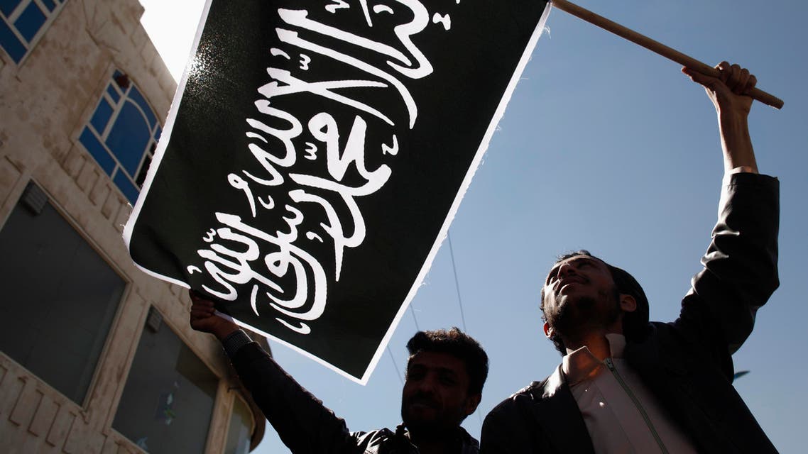 Protesters wave a flag as they demonstrate to denounce air strikes by U.S. drones outside the house of Yemen's President Abd-Rabbu Mansour Hadi in Sana reuters