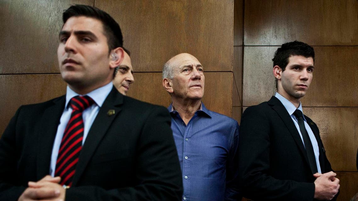 Former Israeli Prime Minister Ehud Olmert (2nd R) waits to hear his verdict at the Tel Aviv District Court March 31, 2014.