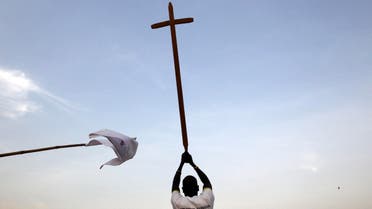 A southern Sudanese man wears a t-shirt reading as he holds up a cross. (File photo: Reuters) 