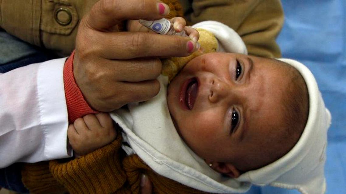 A health worker administers a polio vaccination to a child in Damascus November 20, 2013. (Reuters)