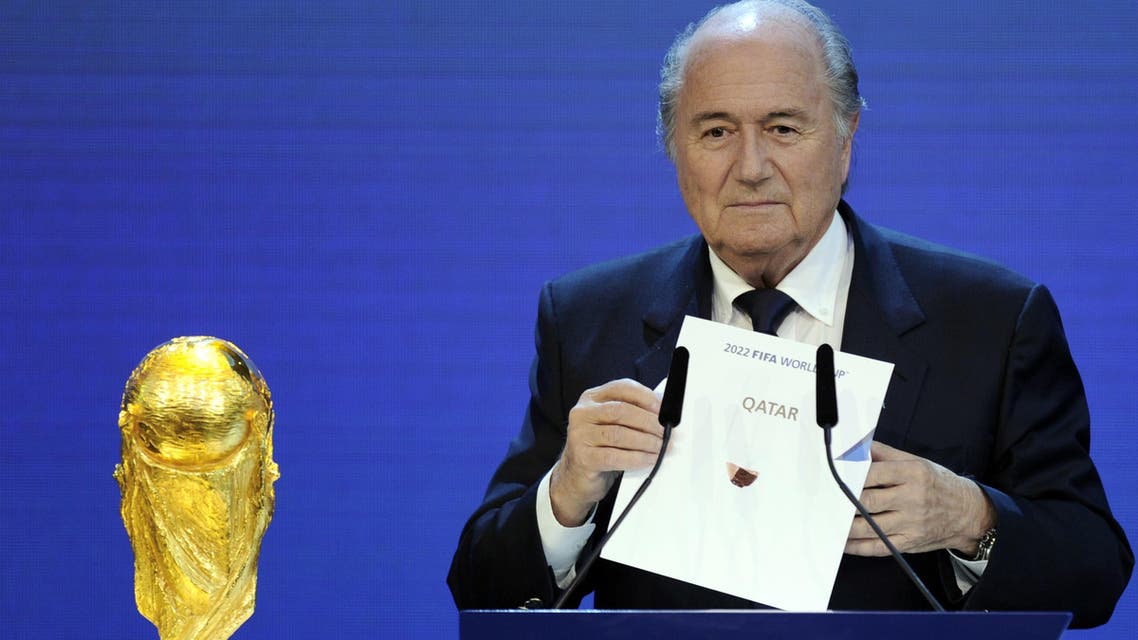 FIFA President Sepp Blatter holding up the name of Qatar during the official announcement of the 2022 World Cup host country at the FIFA headquarters in Zurich. (AFP)