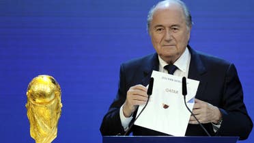 FIFA President Sepp Blatter holding up the name of Qatar during the official announcement of the 2022 World Cup host country at the FIFA headquarters in Zurich. (AFP)