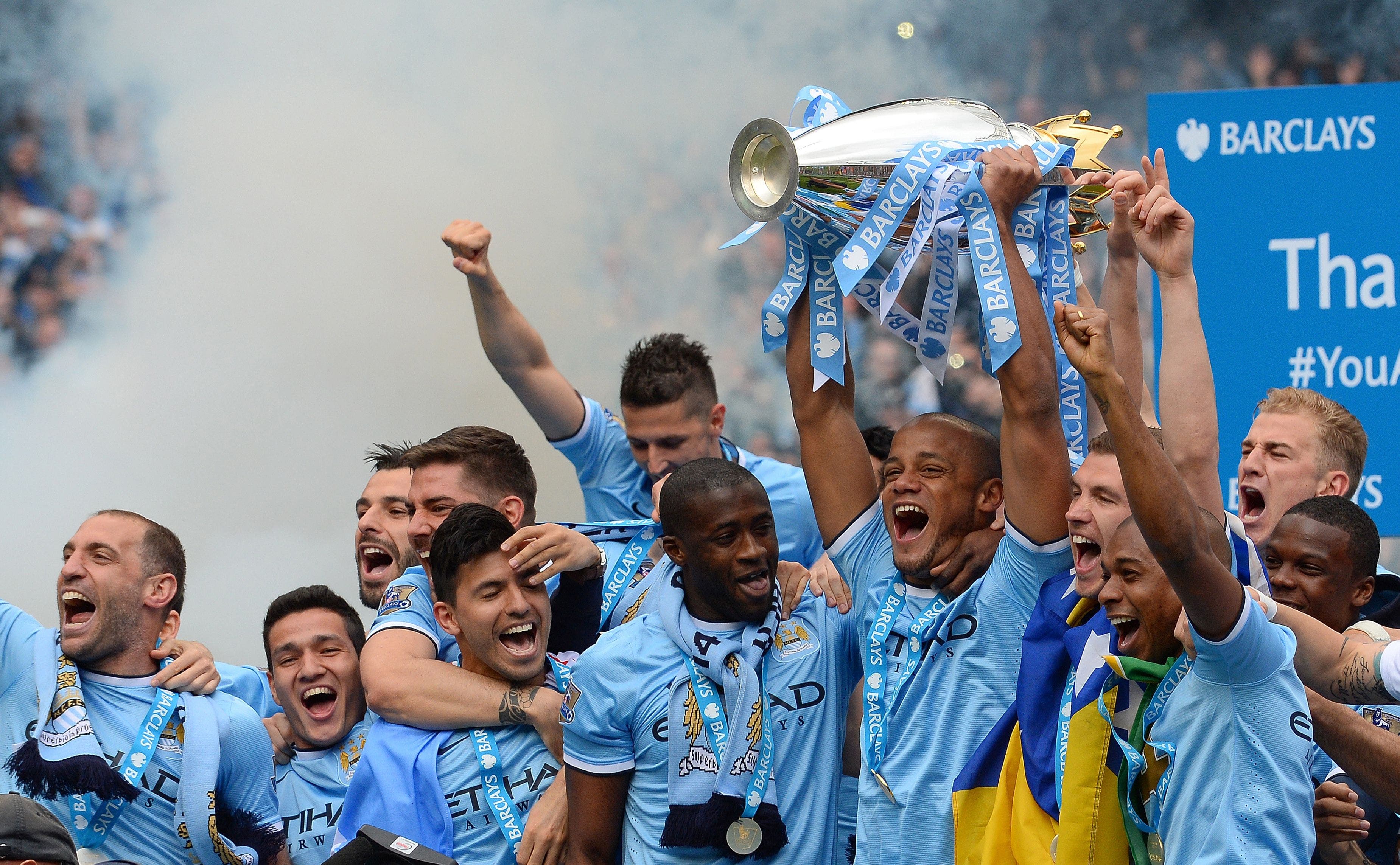 Manchester City players celebrate with the Premiership trophy on May 11, 2014. (AFP)