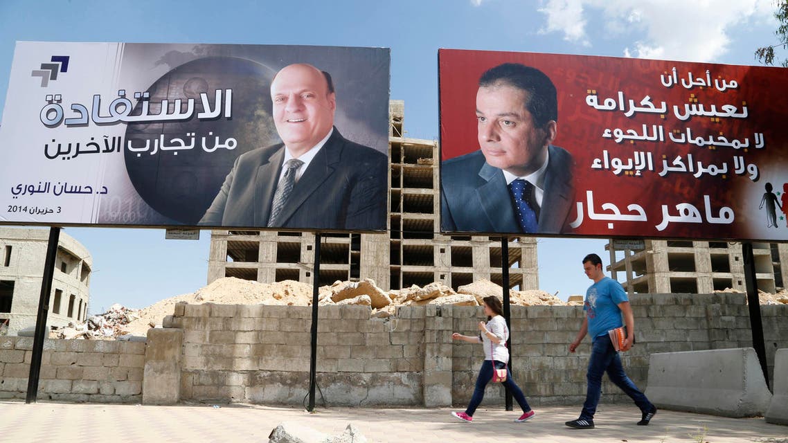 Election campaign posters for presidential candidate Maher Abdul-Hafiz Hajjar (R) and Hassan Abdallah al-Nouri are seen along a street in Damascus May 12, 2014. reuters