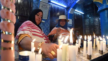  Jewish pilgrims light candles in the Ghriba synagogue on the Mediterranean resort island of Djerba on May 18, 2014. AFP