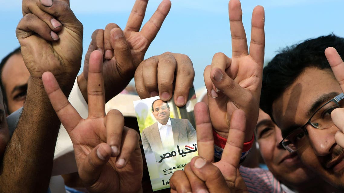 Egyptian expatriates living in Kuwait hold an image of Egypt's ex-army chief and presidential candidate Abdel Fattah al-Sisi, afp