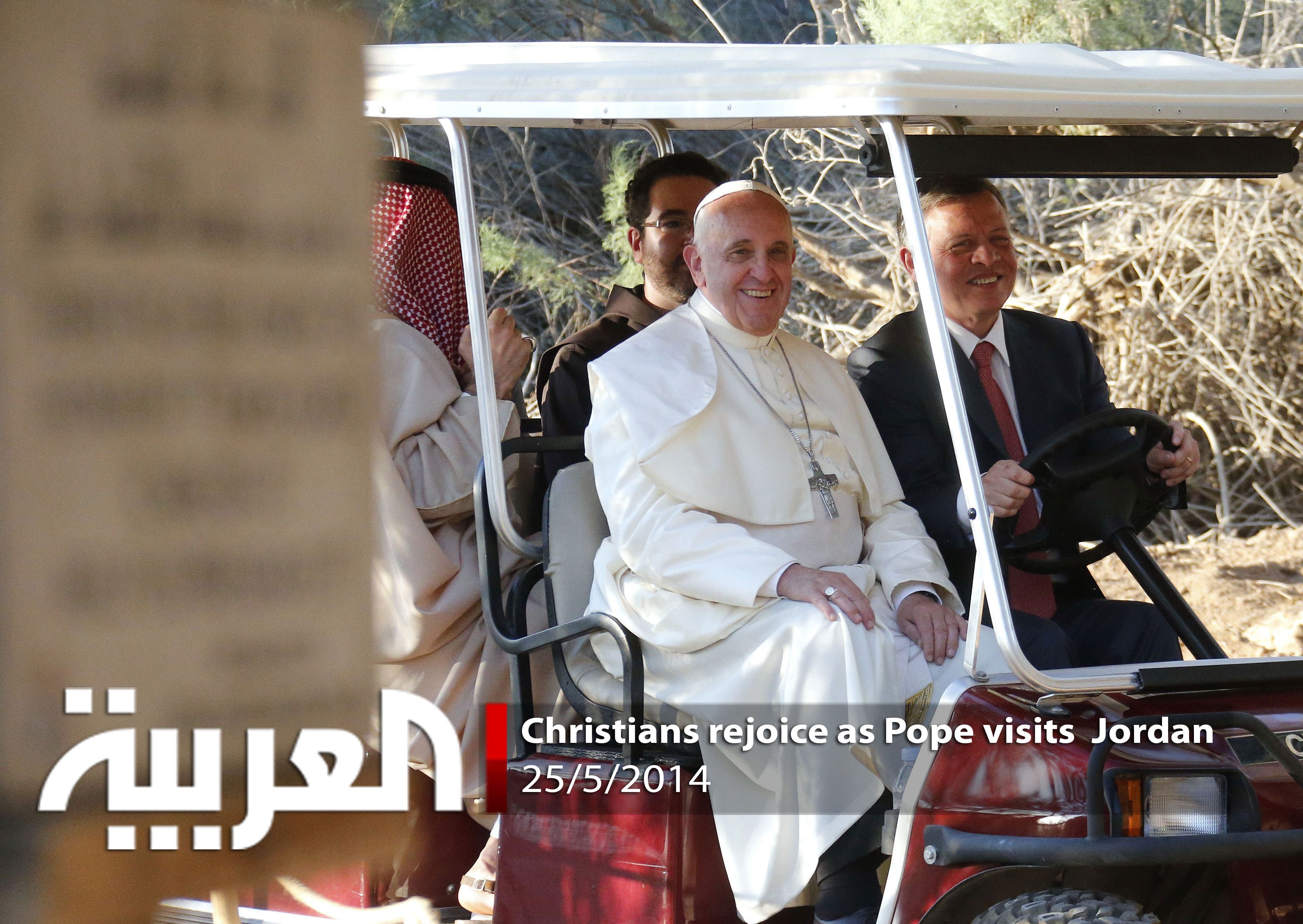 Pope Francis (L) sits next to King Abdullah II's religious affairs adviser as he meets with refugees at a church in Bethany, a site on the eastern bank of the River Jordan where some Christians believe Jesus was baptised, on May 24, 2014.