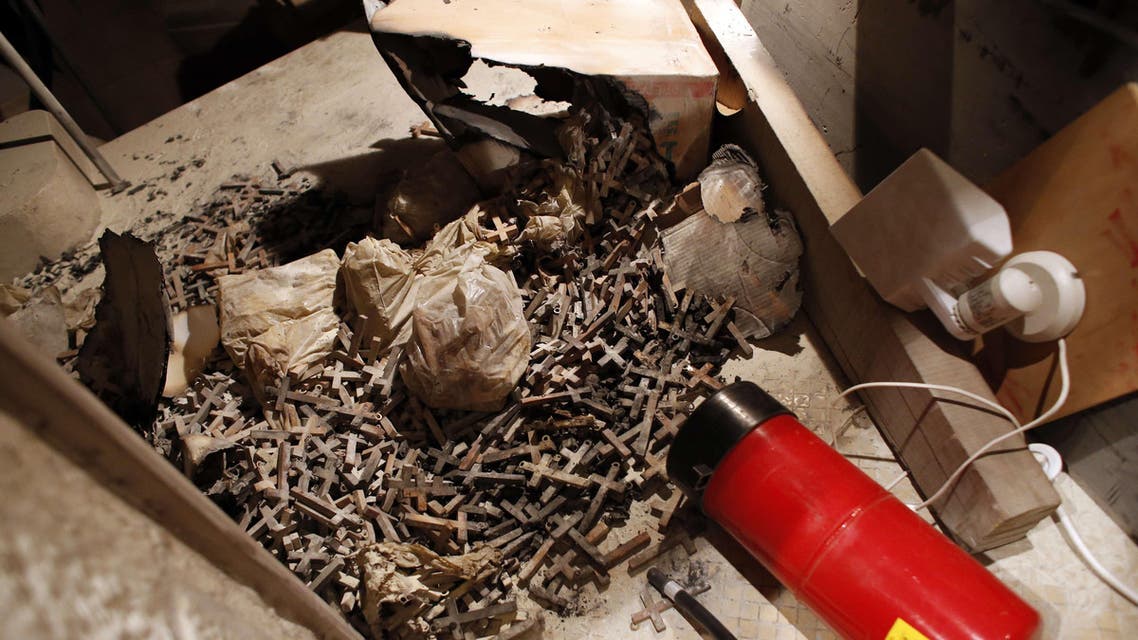 A picture taken on May 26, 2014 shows burnt wooden crosses and a fire extinguisher after arsonists set fire to a Catholic church at a contested site in Jerusalem during a visit by Pope Francis. (AFP)