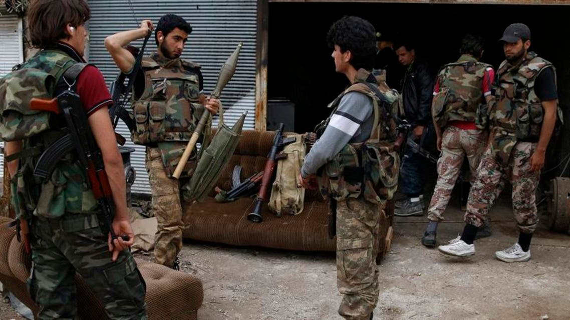Rebel fighters hold their weapons during preparations ahead of what they said was an offensive against forces loyal to Syria's President Bashar al-Assad in Maarat Al-Nouman, Idlib province May 5, 2014. Picture taken May 5, 2014. REUTERS/Rasem Ghareeb (SYRIA - Tags: POLITICS CIVIL UNREST CONFLICT)